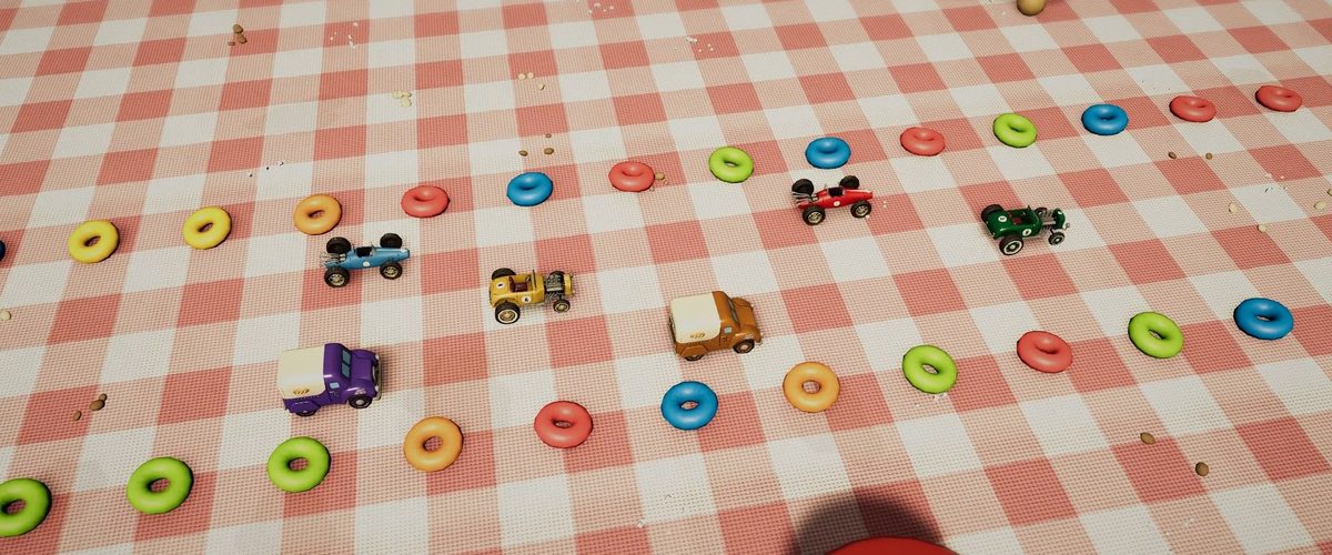 Coches de juguete corren entre aros de cereales sobre un mantel de picnic